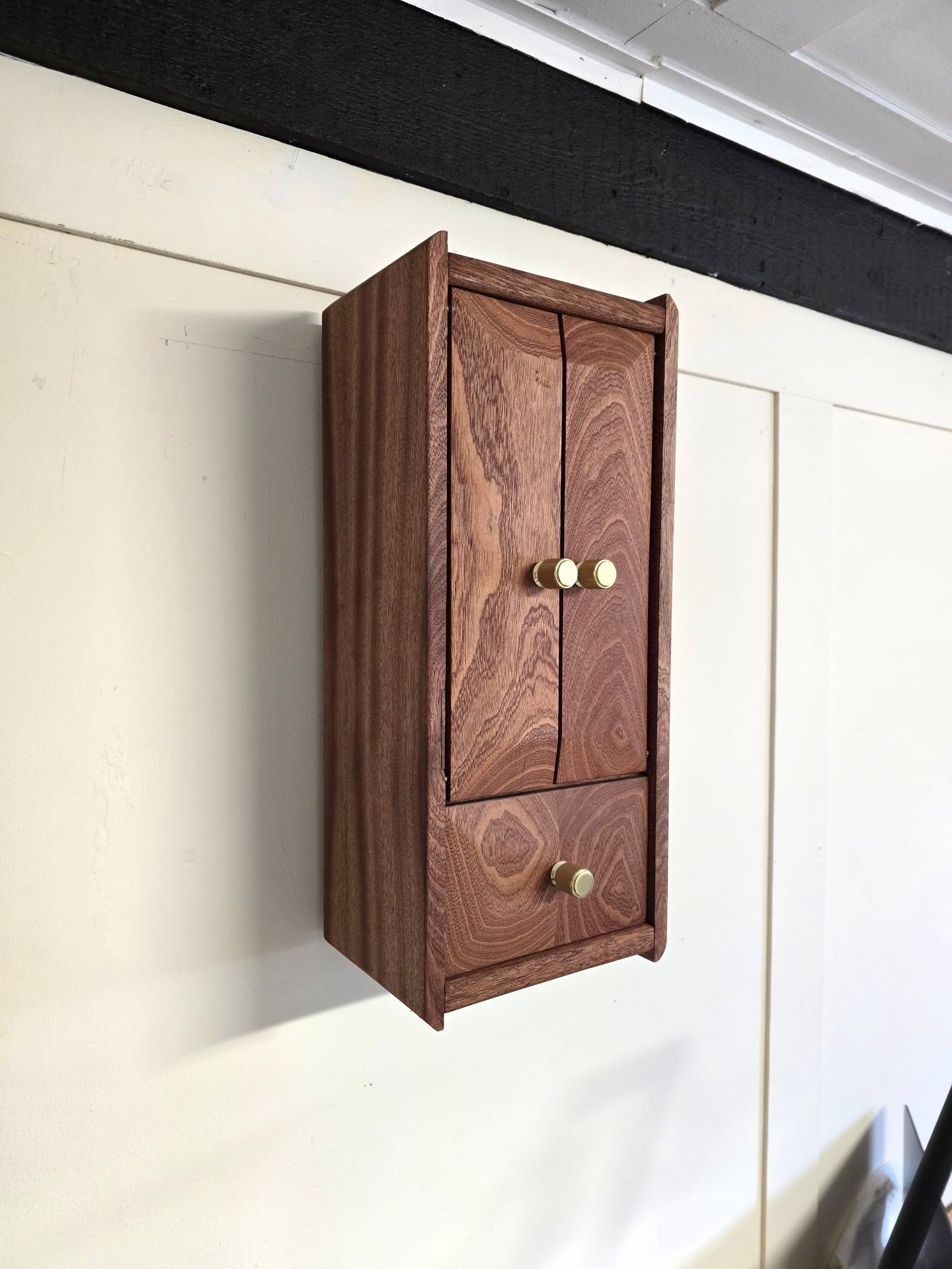 Custom hardwood whiskey cabinet with brass handles